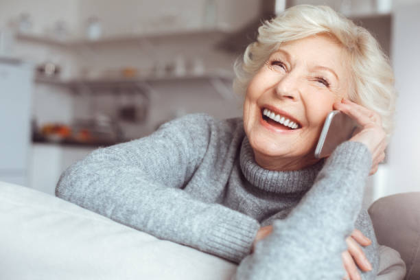 Senior man happily using phone with Eldia